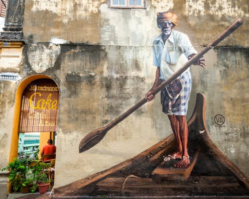 George Town, Malaysia - October 24, 2015: Street art painting of elderly man with oar in boat by Ernest Zacharevic. Street art is recongizable landmark in George town. October 2015